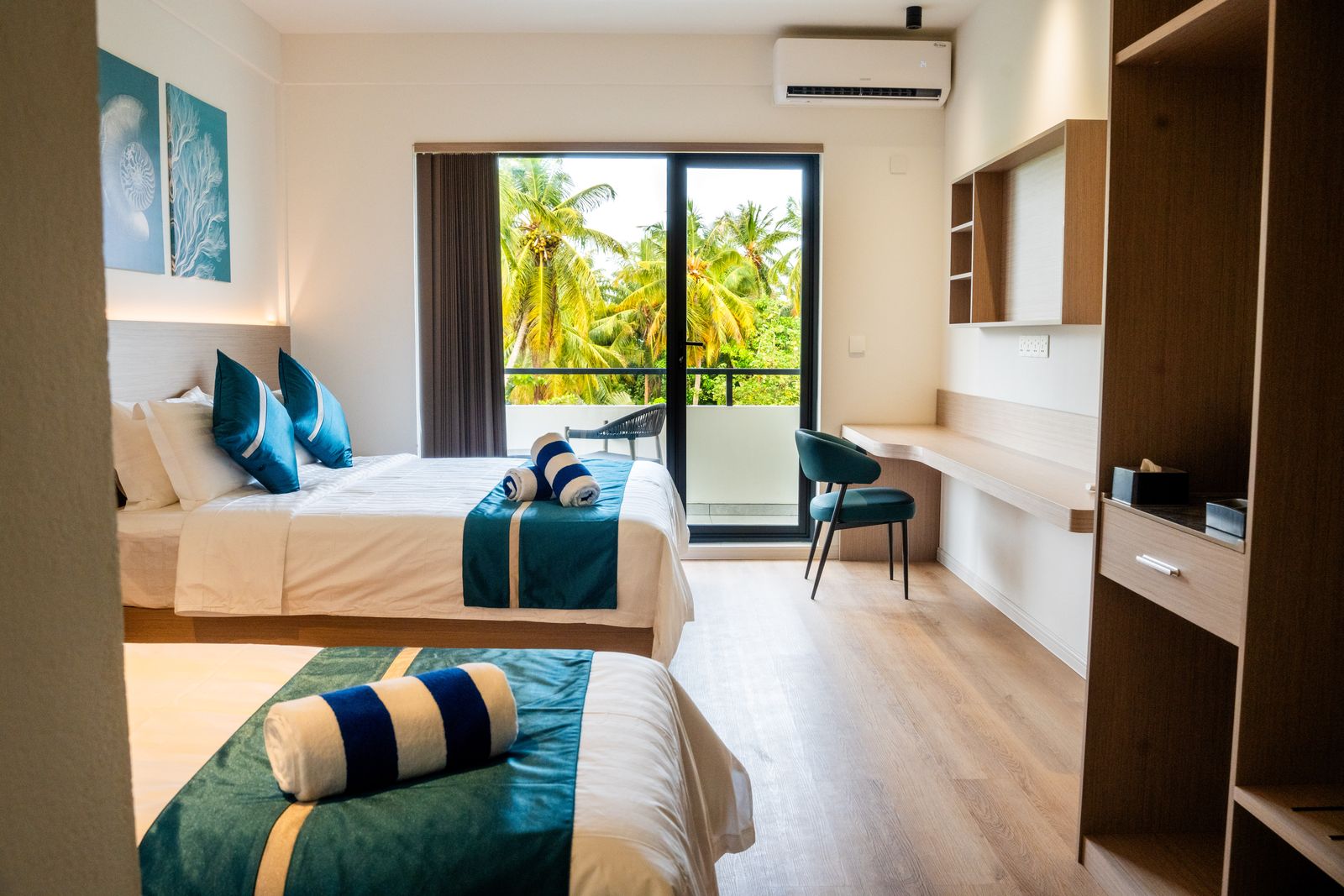 Family room with double and single beds opening to a balcony
