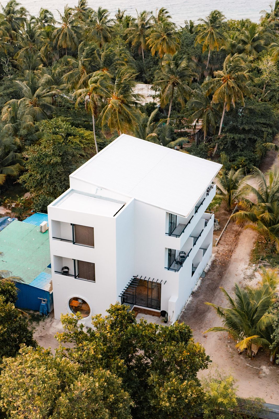 Kashiveli guesthouse from above, framed by coconut palms