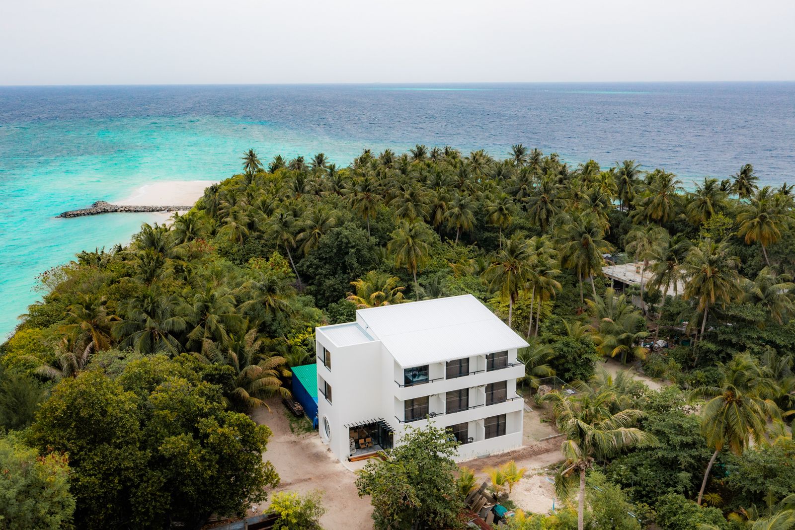 The guesthouse above the lagoon and its white sand spit