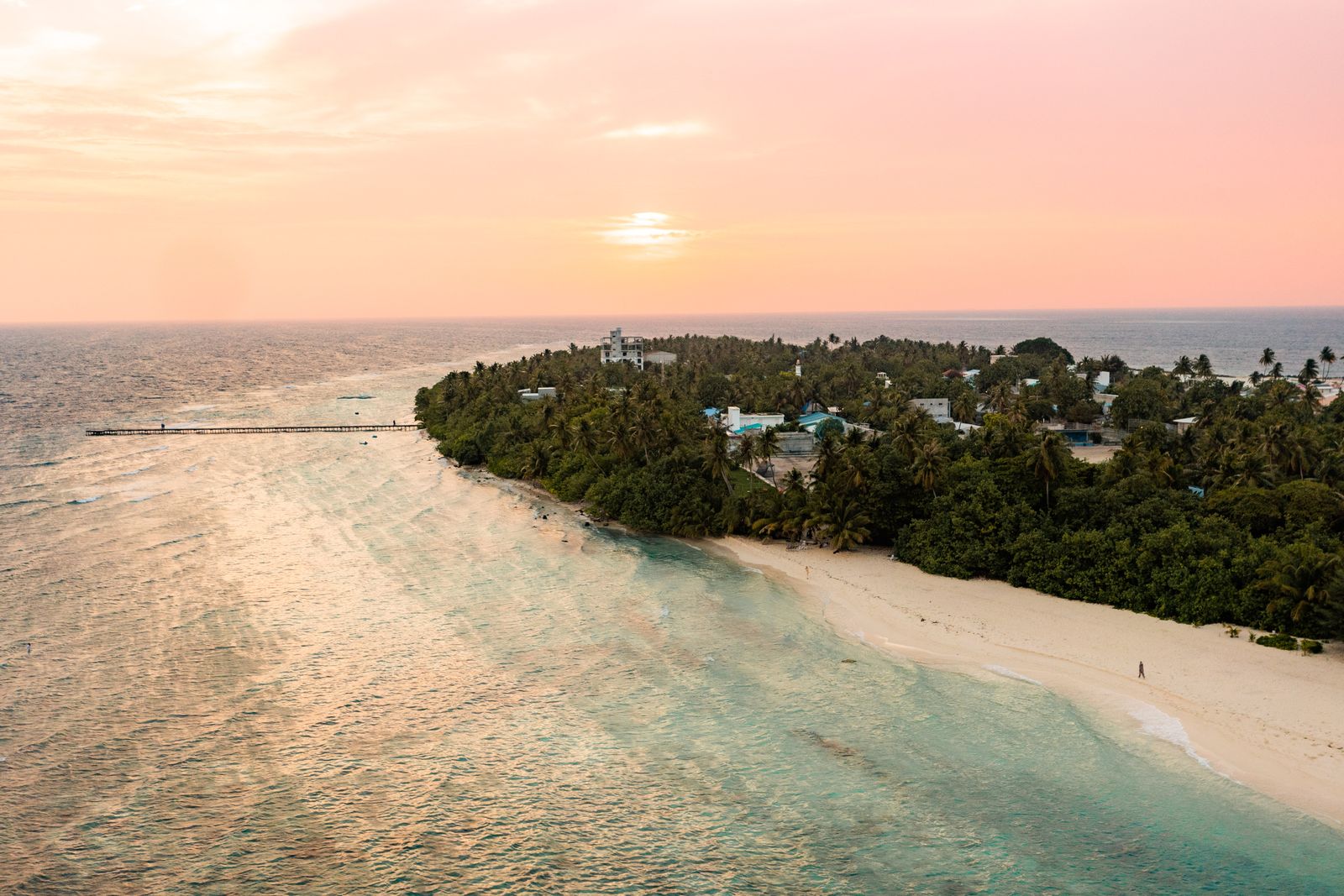 Golden hour over the island and its long wooden jetty