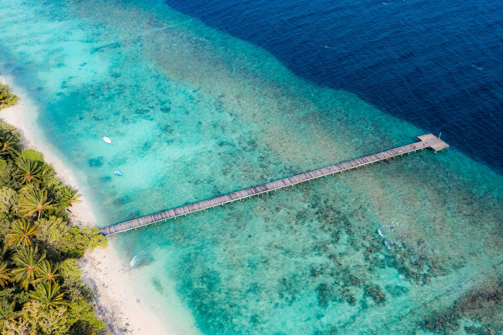 Omadhoo's wooden jetty reaching across the reef to deep water