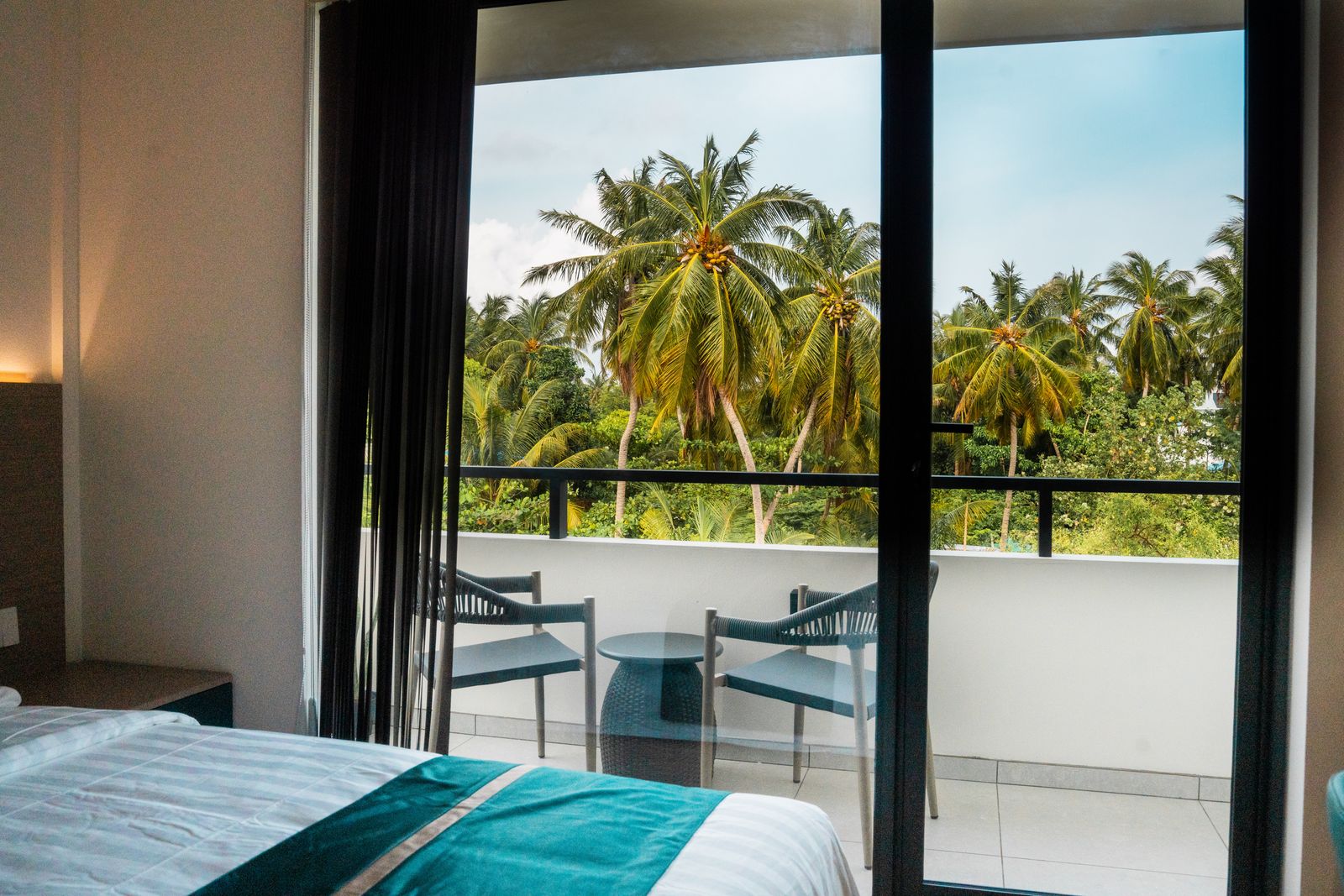 Balcony seating for two overlooking coconut palms