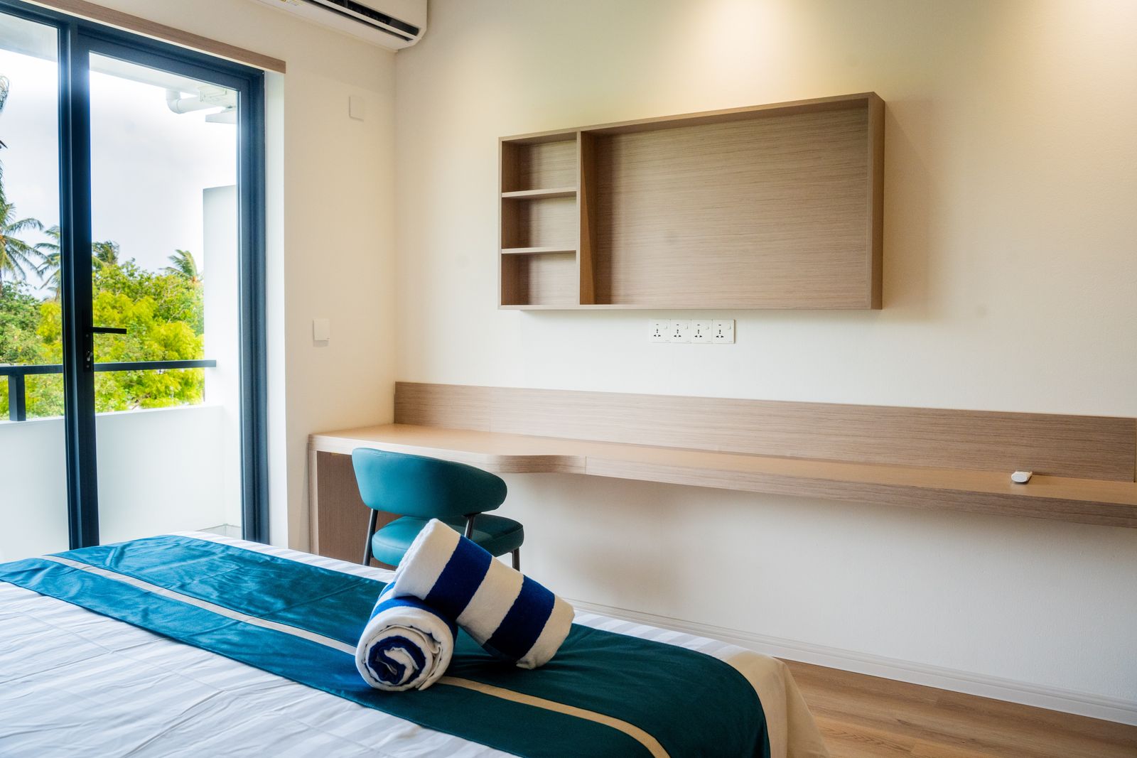 Desk and shelving beside the balcony door