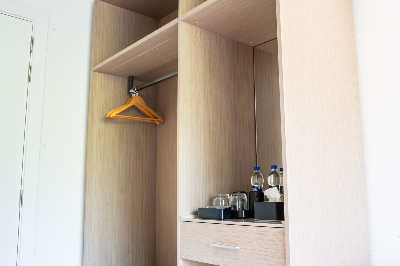 In-room wardrobe with hangers, kettle and complimentary water