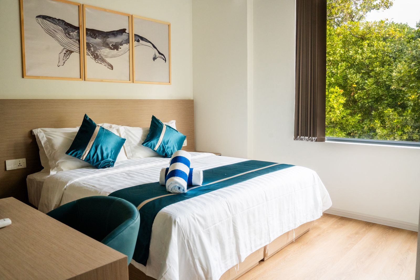 Guest room with humpback whale triptych above the bed