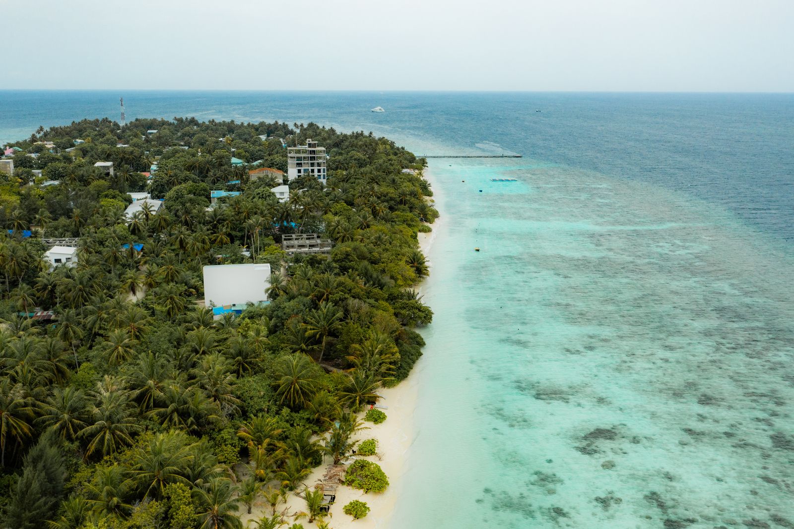 Omadhoo village along the shore with the jetty beyond